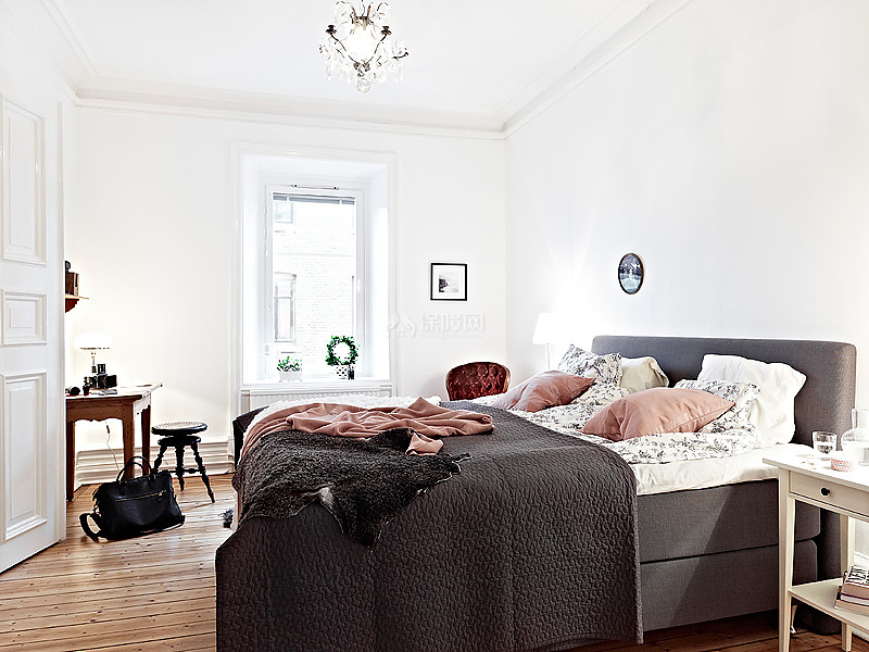 卧室的设计很明朗。简单的白色墙壁，实木地板和深灰色