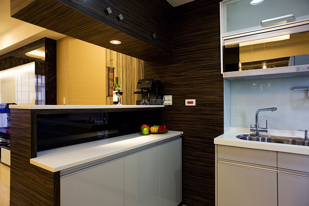 吧台与厨房利用人造石檯面、黑色烤玻作机能上的连接，
